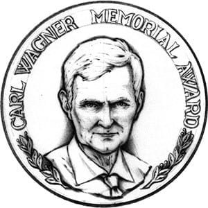 El Premio Conmemorativo Carl Wagner se estableci&oacute; en 1980 para reconocer los logros a mitad de carrera, la excelencia en las &aacute;reas de investigaci&oacute;n de inter&eacute;s de la Sociedad y las contribuciones significativas en la ense&ntilde;anza o la orientaci&oacute;n de estudiantes o colegas en la educaci&oacute;n, la industria o el gobierno.