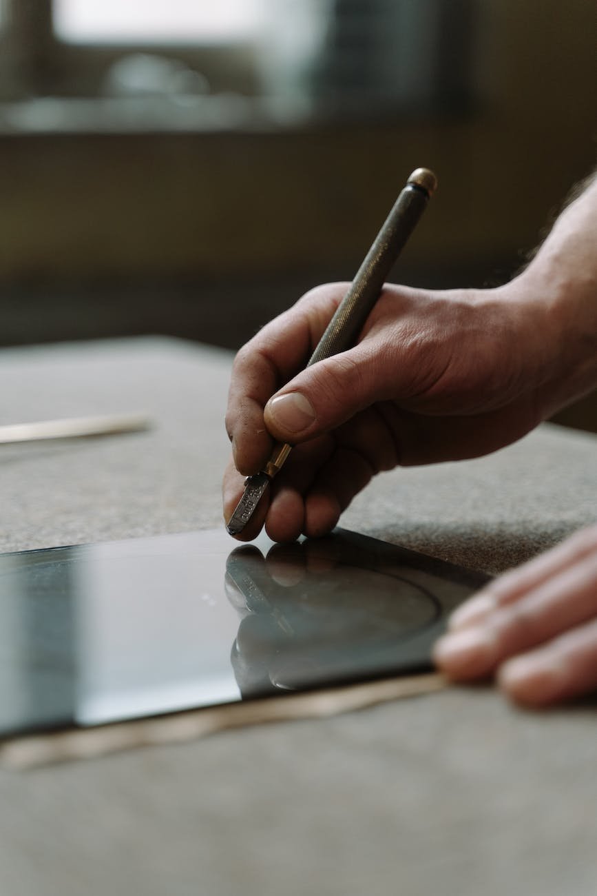 a person holding a glass cutter